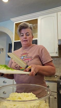 a woman is holding a tray with food in it