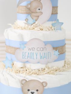 a three tiered cake with a teddy bear on it's top and the words, we can bearly wait