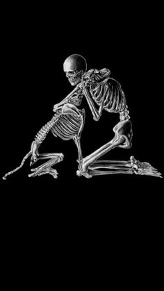 a skeleton sitting on the ground with its legs crossed and one leg bent over it's head