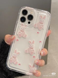 someone holding up their phone case with some bunny stickers on it