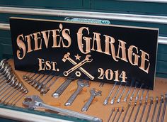 there is a sign that says steve's garage and tools are on the table