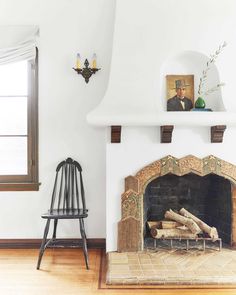 a living room with a fire place and a chair