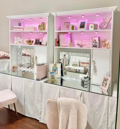 a room filled with furniture and pink lighting