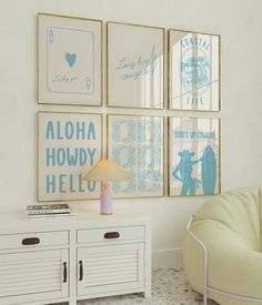 a living room filled with furniture and pictures on the wall next to a white cabinet