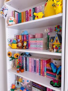 a book shelf filled with lots of books and stuffed animals on top of it's shelves