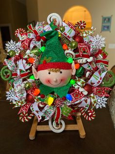 a christmas wreath with a elf's head on it