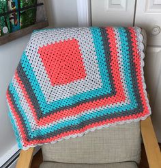 a crocheted blanket sitting on top of a chair