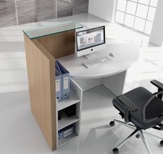 an office desk with a computer on it and a chair in front of the desk