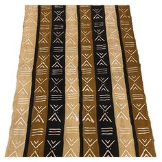 a brown and black rug with white designs on it