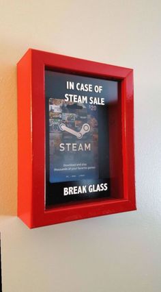 a red frame holds a book in case of steam sale and break glass on the wall