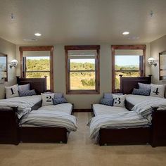 two beds in a room with windows and pictures on the wall above them that have numbers on them