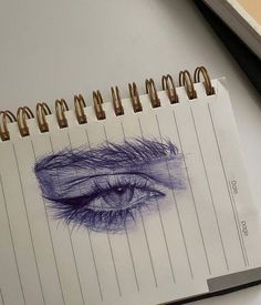 a drawing of an eye on top of a notepad