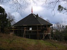 a man is on the roof of a house under construction