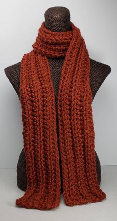 This scarf will keep you cozy and stylish in cold Winter weather. Measures 70 inches long and 5 inches wide. Can be worn multiple ways. Made with a chunky wool blend yarn for warmth and easy care. Machine washable. Orange Crochet Scarf, Big Knitted Scarf, Dark Orange Clothes, Chunky Knitted Scarf, Orange Crochet Ideas, Crochet Fall Scarf, Crochet Winter Scarf, Knitted Scarfs, Unique Knitwear