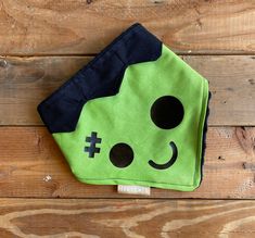 a green and black bag sitting on top of a wooden floor