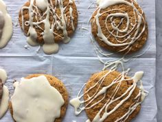 four cookies with white icing on top of them