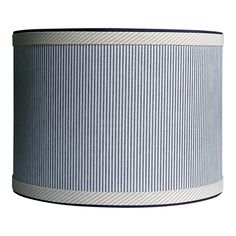 a blue and white striped lamp shade on a white background with black trimmings