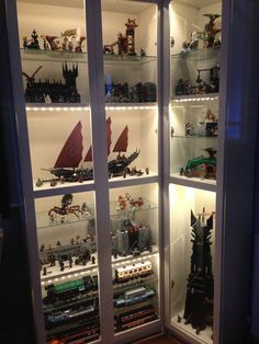 a display case filled with lots of toy figurines and other toys in it