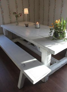 a white table and bench in a room