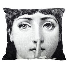 a black and white pillow with an image of a man's face on it