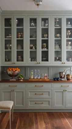 a kitchen with wooden floors and gray cabinets