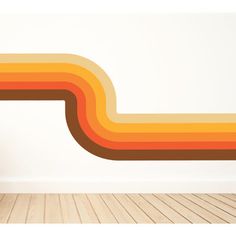 an orange and yellow striped wall decal in the corner of a room with hardwood flooring