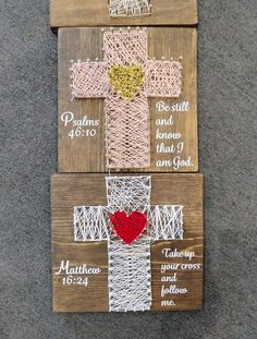 three wooden crosses with string wrapped around them and a red heart on the bottom one