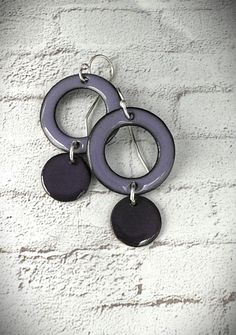 These earrings are fun and full of color!   Copper washers and disc shaped dangles are combined to make these purple earrings.  The washers (about 20 mm in diameter) have been kiln fired using multiple layers of bright mauve purple enamel while the tiny dangles have been fired with a dark iris purple enamel (think eggplant).  Edges have been filed to leave the copper exposed, but there is still a slight burnt edge for a more organic feel.  These earrings measure slightly longer than an inch in length.  The two shapes are joined by a sterling silver jump ring and the ear wires were hand forged from sterling silver wire. I offer two sizes of double cascading halo earrings.  This listing is for the small size (seen in the first 7 photos).  The 8th photo shows the comparison between the large Iris Purple, Mauve Purple, Halo Earrings, Purple Earrings, Enamel Earrings, Silver Wire, Eggplant, Favorite Jewelry, Jewelry Earrings Dangle