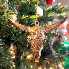 an ornament hanging from the top of a christmas tree