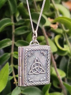 "Book of Shadows Triquetra Grimoire Locket Pendant 20\" Curb Chain Necklace  925 Sterling Silver Talisman Amulet Pagan Wiccan (WPSLP) 13gram Approx 28mm x 18mm x 5mm Item has a filigree corners. The book has a clasp closure and also as pictured illusion pages around the edge FREE GIFT BOX (May Vary) Your item is 100% Sterling silver and may tarnish as all silver does. It is well known silver reacts with the elements this may be caused by highly acidic perspiration or contact with other chemical Spiritual Necklace With Sterling Silver Clasp As Gift, Bohemian Sterling Silver Locket, Sterling Silver Charms Necklace For Collectors, Spiritual Antique Silver Charms Jewelry, Antique Silver Spiritual Charms Jewelry, Spiritual Antique Silver Jewelry With Charms, Antique Silver Spiritual Jewelry With Charms, Spiritual Charms Necklaces For Collectibles, Antique Silver Locket Necklace In Sterling Silver