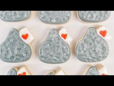 decorated cookies in the shape of rocks with hearts on them are arranged to look like they have been made from frosting