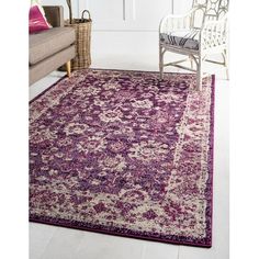 a purple and white area rug in a living room