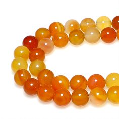 an orange and yellow beaded necklace on a white background with space in the middle