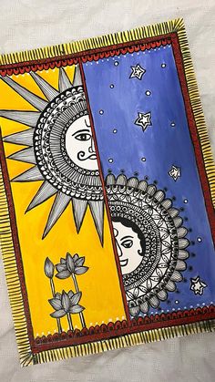 two sun and moon paintings on a white sheet