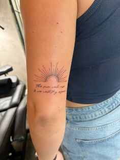 a woman with a tattoo on her arm that reads, the sun will rise again