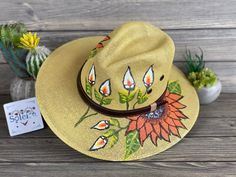 This beautiful Mexican Sombrero has beautiful hand painted flowers, perfect to add that special touch to any outfit. The hat itself is made out of jute material and is very light and breathable. This Mexican Sombrero is made with love by Mexican Artisans. Bohemian Adjustable Sun Hat With Flower Shape, Adjustable Bohemian Sun Hat With Flower Shape, Bohemian Adjustable Flower Sun Hat, Adjustable Bohemian Flower Sun Hat, Bohemian Adjustable Hand Painted Sun Hat, Bohemian Wide Brim Hand Painted Straw Hat, Bohemian Hand Painted Wide Brim Straw Hat, Country Style Hand Painted Hat For Summer, Country Style Hand Painted Summer Hat