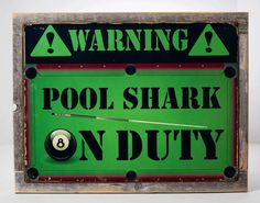 a pool shark on duty sign mounted to a wooden frame with eight ball and cues