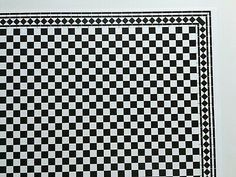 a black and white checkerboard pattern is on the wall