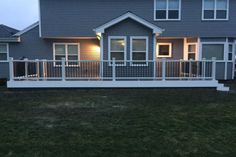 a house with a deck and lights on it