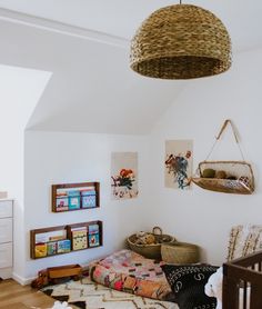 a baby's room with white walls and wooden floors