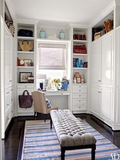 an image of a room with white cabinets and furniture in it, including a bench