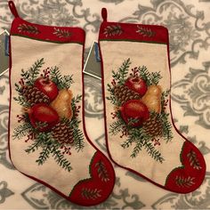 two stockings with apples and pine cones on them