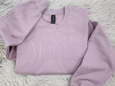 Wrap yourself in cozy comfort with this beautifully embroidered Mama sweatshirt in a stunning dusty lavender shade. Crafted from soft, high-quality fabric, this sweatshirt is perfect for moms who want to look stylish while staying comfy. The minimalist "Mama" embroidery across the chest adds a sweet, personal touch, making it a wonderful gift for new moms, expectant moms, or any mama who loves a cozy outfit. 💎 What sets our garments apart? The intricate embroidery! Here's why embroidered design Winter Loungewear Tops With Letter Embroidery, Cozy Long Sleeve Tops With Letter Embroidery, Winter Loungewear Tops With Embroidered Graphics, Winter Loungewear Sweater With Embroidered Logo, Winter Embroidered Tops For Loungewear, Winter Embroidered Sweater For Loungewear, Custom Embroidered Sweatshirt For Winter Loungewear, Long Sleeve Sweater With Embroidered Text For Loungewear, Winter Custom Embroidery Sweatshirt For Loungewear