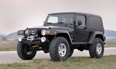 a black jeep parked on the side of a road