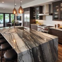 a kitchen with marble counter tops and dark wood cabinets