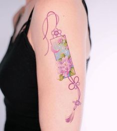 a woman with a flower tattoo on her arm