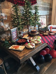 a table topped with lots of food next to a christmas tree and other foods on top of it