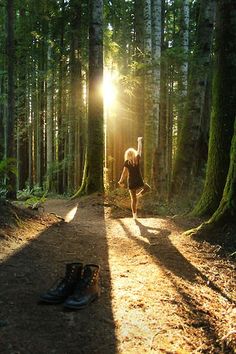 a person walking through a forest with the sun shining down on them and there is a quote above it