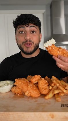 a man is holding up some food in front of him