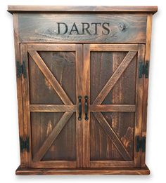 a wooden cabinet with two doors and the words darts on it